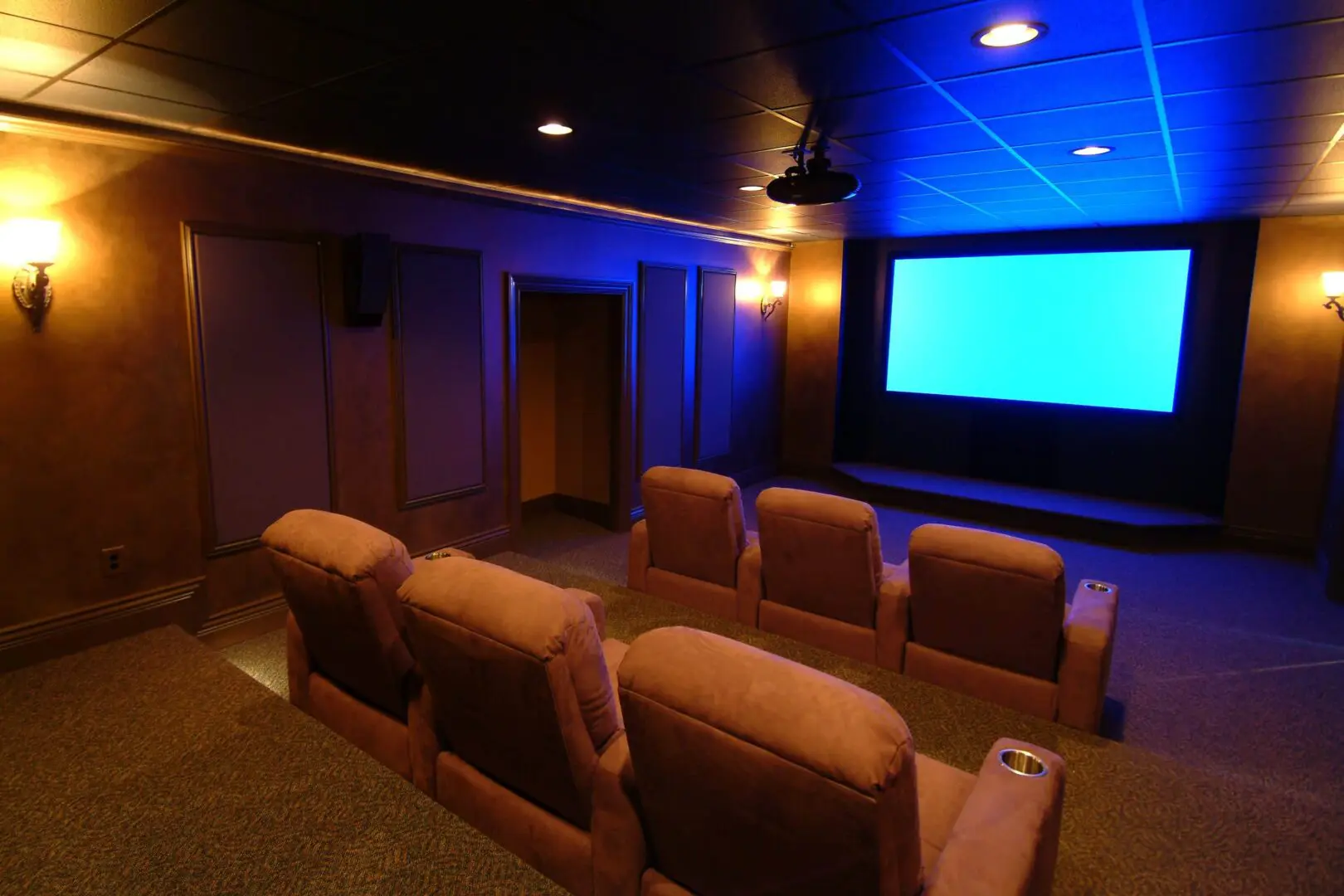 A cozy home theater with comfortable seats and a large screen.
