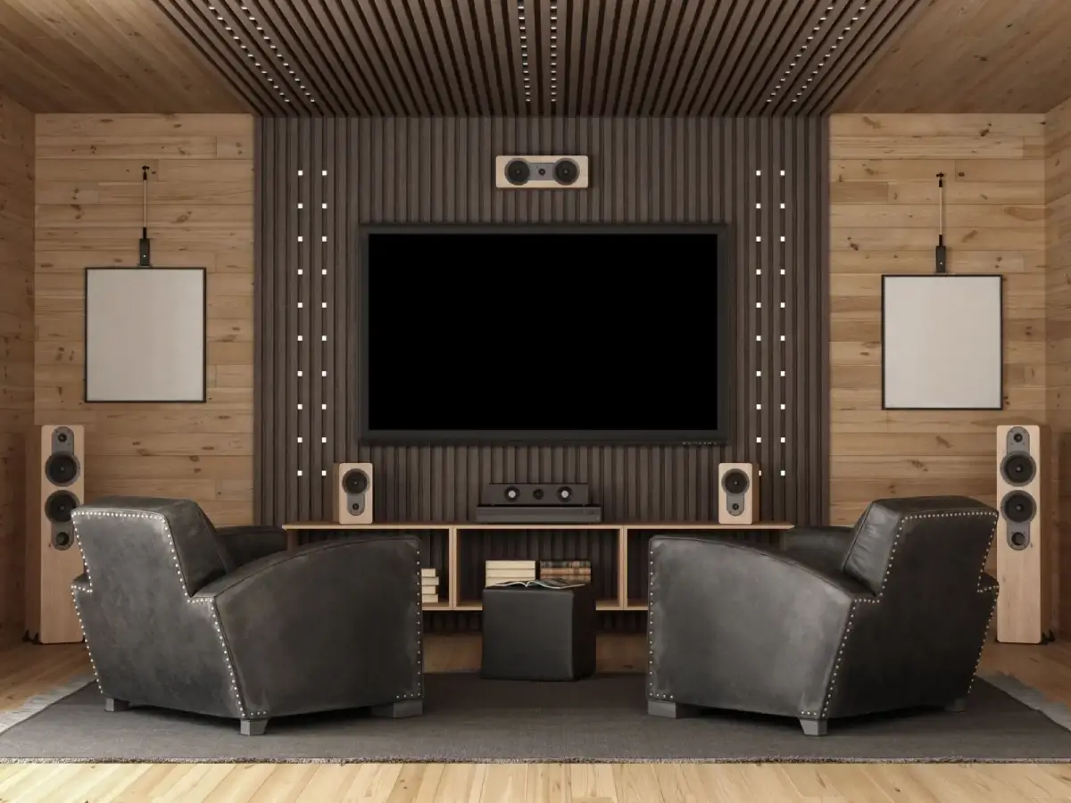 Home theater with leather chairs and speakers.
