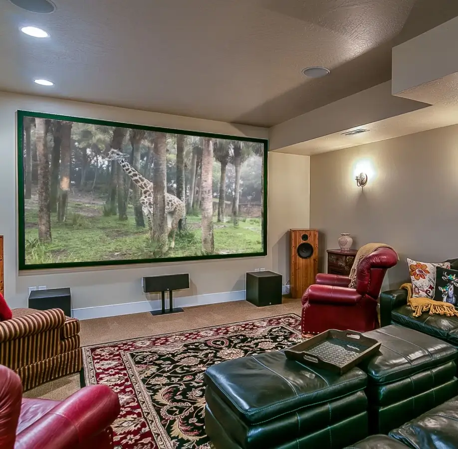Home theater with large screen and seating.