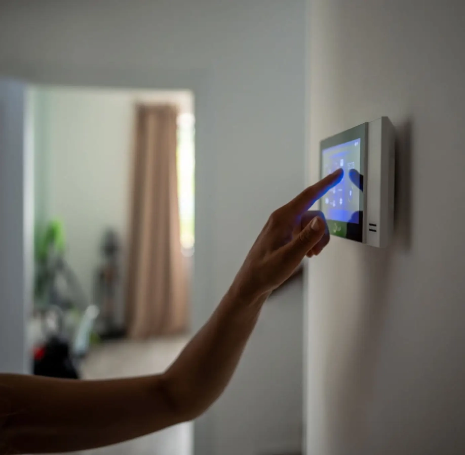 Hand adjusting home smart thermostat device.