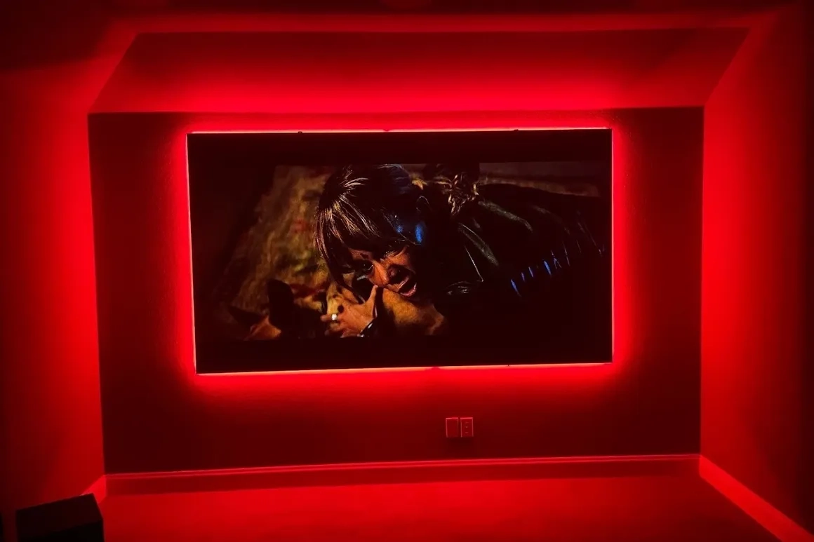 Home theater with red ambient lighting.