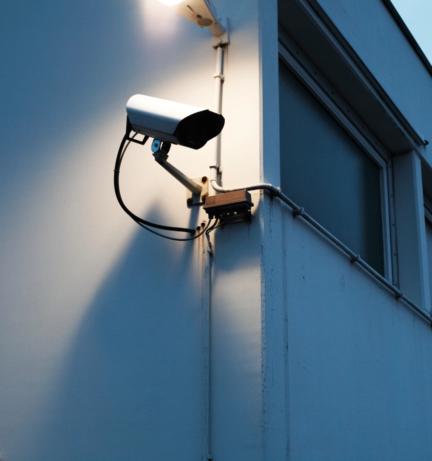 Security camera mounted on building corner.
