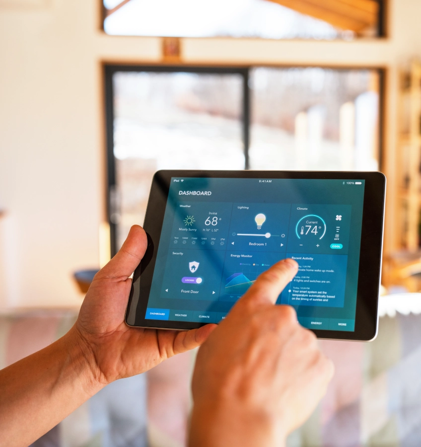 Person using tablet for smart home control.