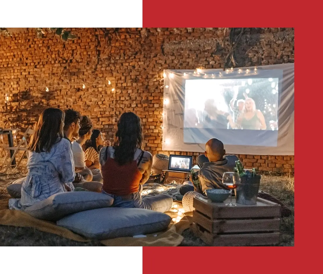 Outdoor movie night with friends and lights.