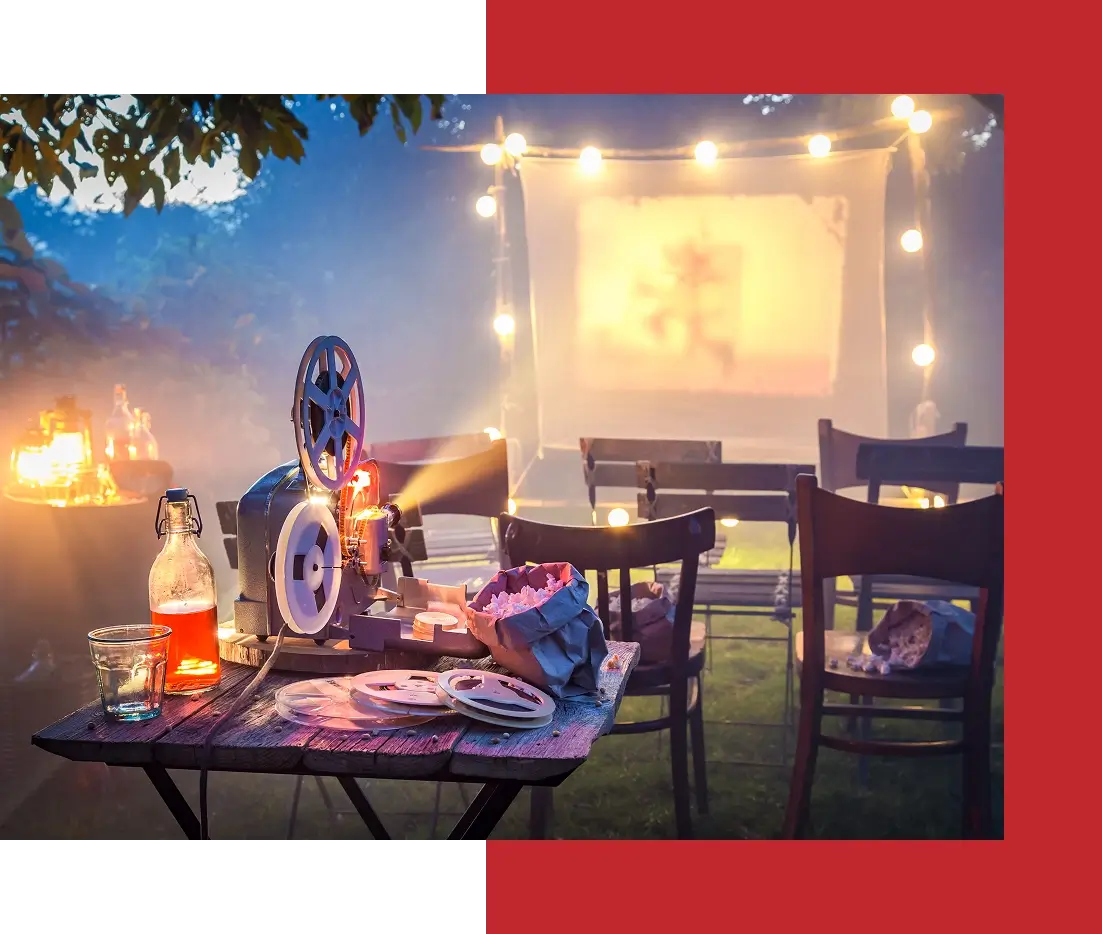 Outdoor movie night with projector and screen.