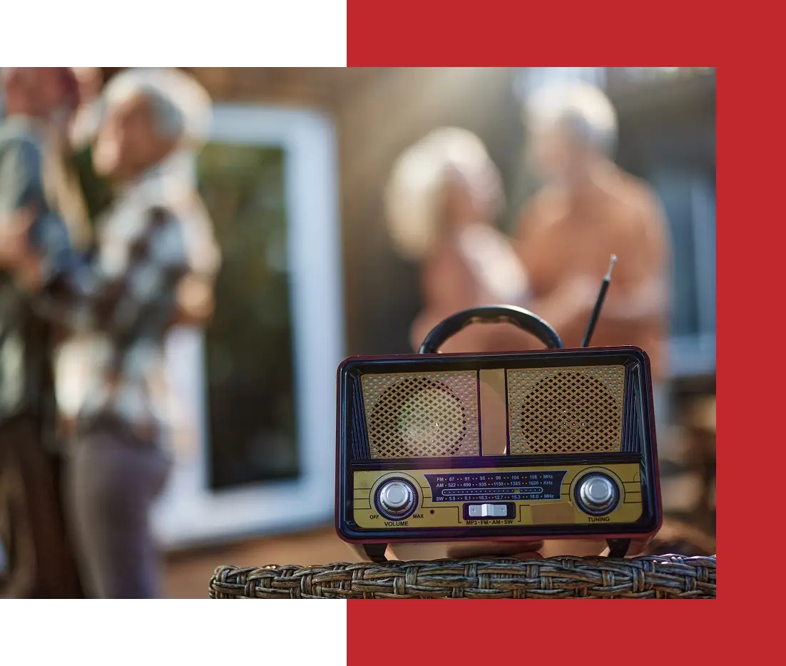 Retro radio with blurred dancing couple background.