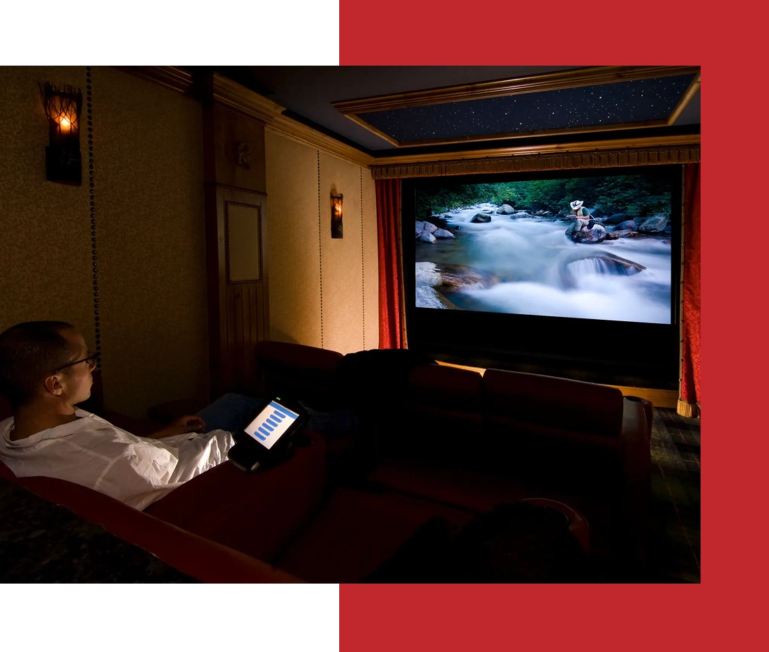 Man watching movie in home theater room.