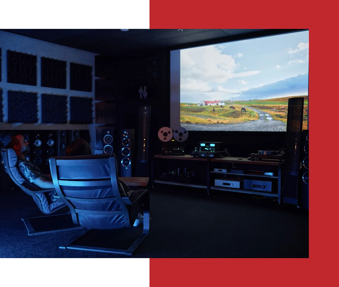 Home theater with large screen and speakers.